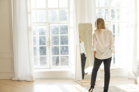 Beautiful blonde in underwear and dress posing on a white backgroundの写真素材