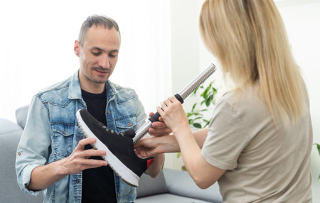 Modern Hospital Physical Therapy: Doctor Uses Tablet Computer, Helps Disabled Patient with Injury...