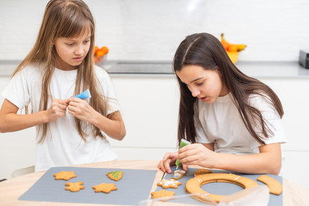 Cooking Christmas gingerbread. Child decorating cookies. Festive homemade decorated sweetsの写真素材