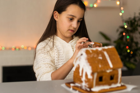 Young girl making gingerbread cookies at home.の写真素材