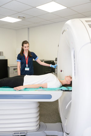 Radiologist with a female patient in the room of computed tomography.の写真素材