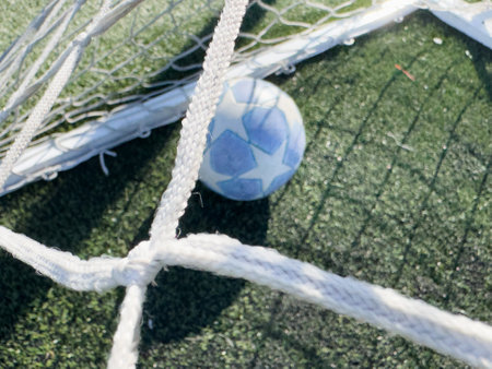 Soccer ball on a grass football fieldの写真素材