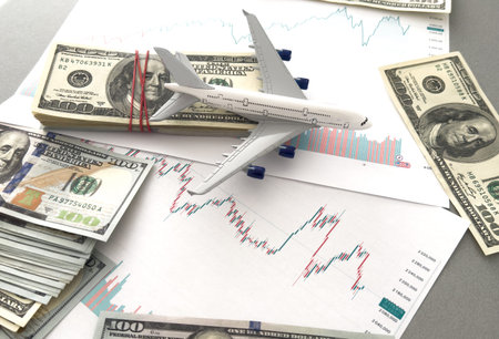 Airplane model on financial reports background
