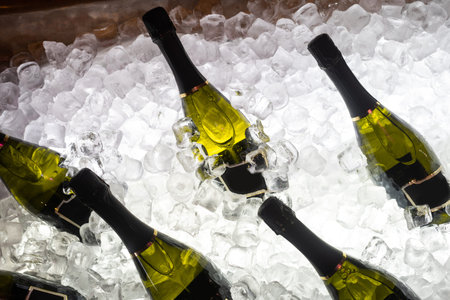 champagne bottles in a bucket with ice, top view