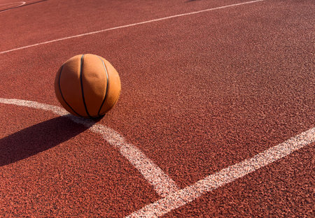 Basketball ball in the outdoors court sunny dayの写真素材
