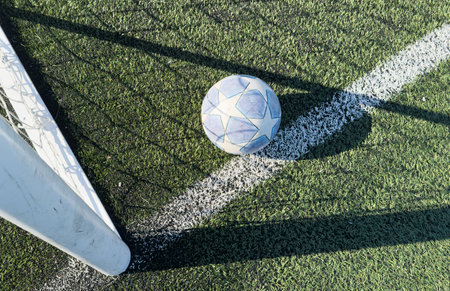 soccer ball flies into the gate on a green background. Close up.の写真素材