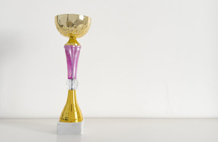 A golden trophy atop sleek black standの写真素材