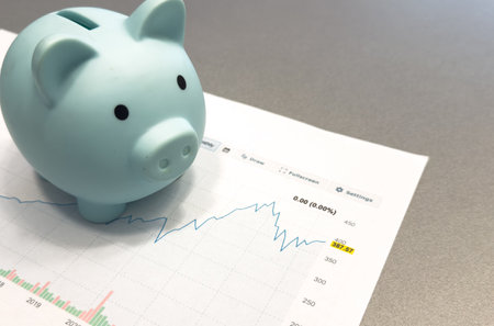 Financial planning objects - piggy bank, graph a colour background.の写真素材