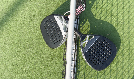 Padel tennis rackets. Sport court and balls.の写真素材