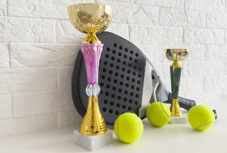 Gold cup with sports equipment, padelの写真素材