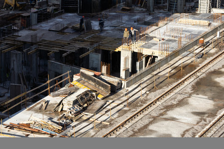 Tower crane on formwork at construction site. Truck mounted concrete pump. Reinforced concreting....