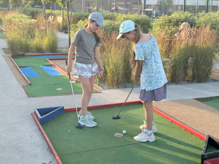 teenage girls play mini golfの写真素材