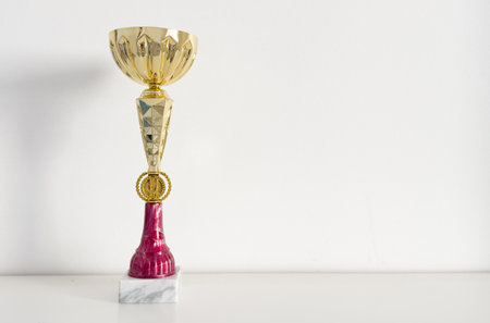 A golden trophy atop sleek black standの写真素材