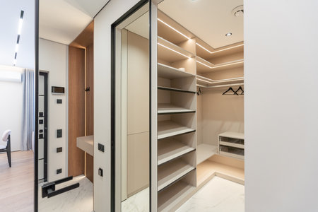 Modern interior, beautiful wardrobe without clothes. Empty wardrobe room with opened shelves. Walk in closet interior conceptの写真素材