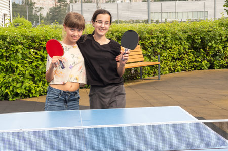 Girl playing ping-pong outdoorsの写真素材
