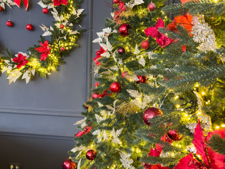 Christmas Tree with Decorations Near a Fireplace with Lightsの写真素材
