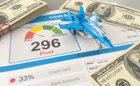 Credit Report text on paper sheet with toy fighterの写真素材