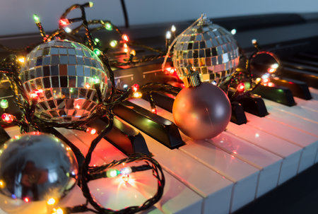 Piano keyboard and Christmas pine tree illuminations. Vibrant colors, Holidays conceptの写真素材