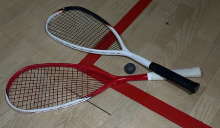 Squash rackets and ball on court floor, top viewの写真素材