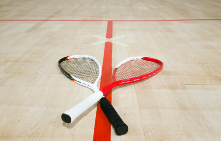 Sports, above and racket on squash court for competition, challenge and training center. Exercise, interior and empty room with top view of wooden floor of gymnasium for games, fitness club and gearの写真素材