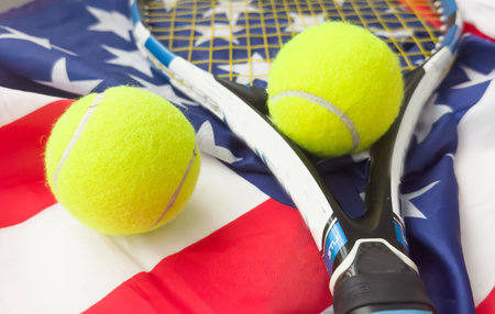A tennis racquet with tennis ball on USA flag. Tennis competition conceptの写真素材