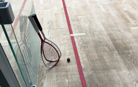 Sports, above and racket on squash court for competition, challenge and training center. Exercise, interior and empty room with top view of wooden floor of gymnasium for games, fitness club and gearの写真素材