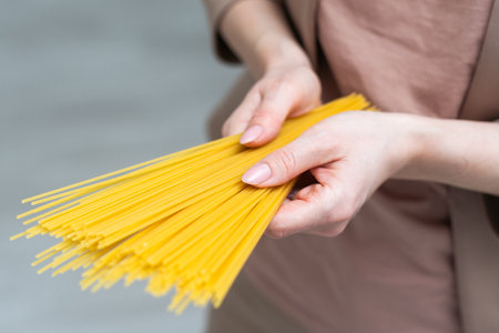 Spaghetti in hand on whiteの写真素材