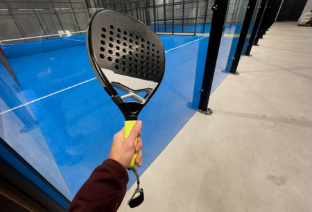 padel racket on a padel court with a ballの写真素材