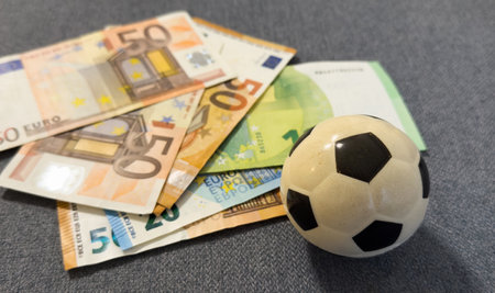 Soccer ball on stack of euroの写真素材