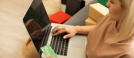 Young woman with laptop and shopping bags at home. Black Friday saleの写真素材