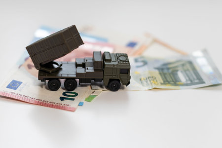 a toy military machine and moneyの写真素材
