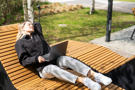 Young woman with laptop outside