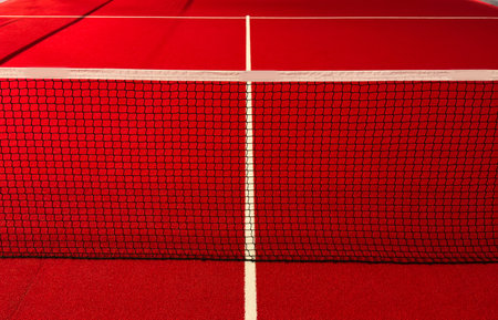 View of the net and the centre line of a red paddle tennis court. Racket sportsの写真素材