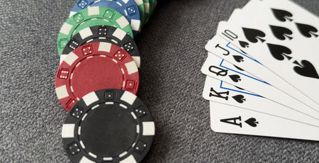 Poker cards and gambling chips on green background