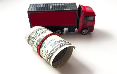 A toy truck carries a dollar rolledの写真素材
