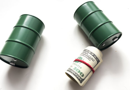 toy oil barrel and dollars in rollの写真素材