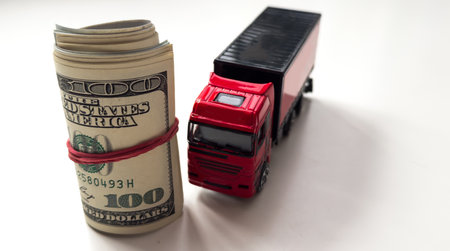 A toy truck carries a dollar rolledの写真素材