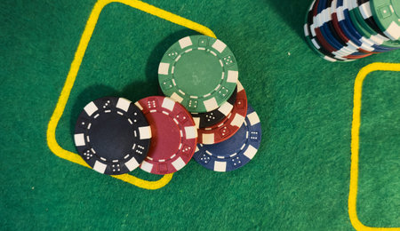 Poker Chips on a gaming table with dramatic lighting