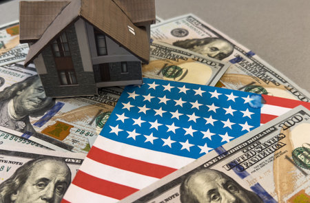 Dollar banknotes and USA national flag. paper houseの写真素材