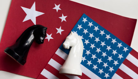 Two chess pieces standing on usa flag and china flag.の写真素材