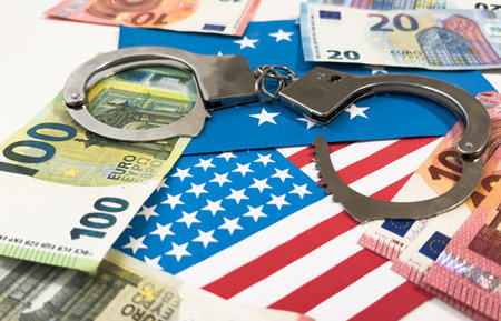 United States of America flag with handcuffs. Currency corruption in the country. Financial crimesの写真素材