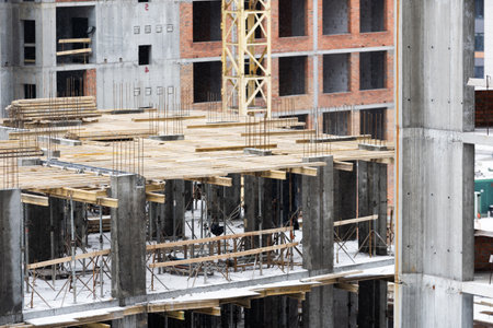 Construction site background. Hoisting cranes and new multi-storey buildings. Industrial background.の写真素材