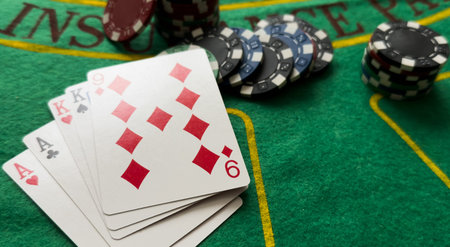 A popular and exciting poker game with a winning combination. Playing cards and chips on a table in...
