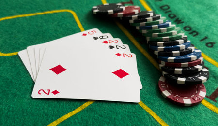 A popular and exciting poker game with a winning combination. Playing cards and chips on a table in...