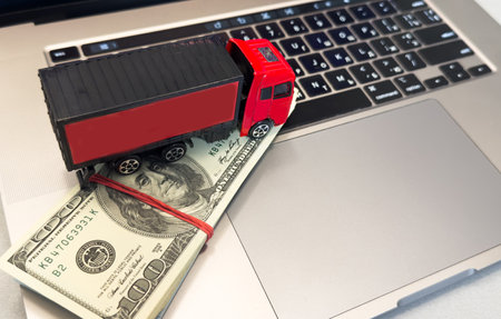 a trailer truck on a laptop computer, depicts wasting time and paying a lot of money to buy things online called online shopping or retail e-commerce, ecommerce conceptの写真素材