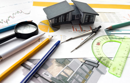 Wooden house and construction tools toy on stone pattern background with copy space.の写真素材