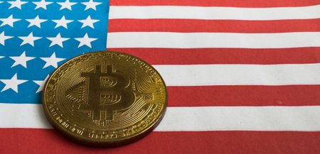 Physical Coin bitcoin with golden piece on USA flag. Bitcoin mining concept.の写真素材