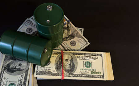 Airplane and money. Plane on the background of USA dollars. The cost of travel, air tickets and flights, financial expenses for vacation.の写真素材