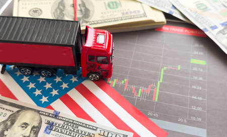 Logistics transportation. Delivery of goods by truck. Accounting for truck company. Calculator and money near truck. Delivery of goods by road. Shipment business. Logistics cost chartの写真素材