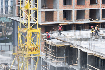 Construction site background. Hoisting cranes and new multi-storey buildings. Industrial background.